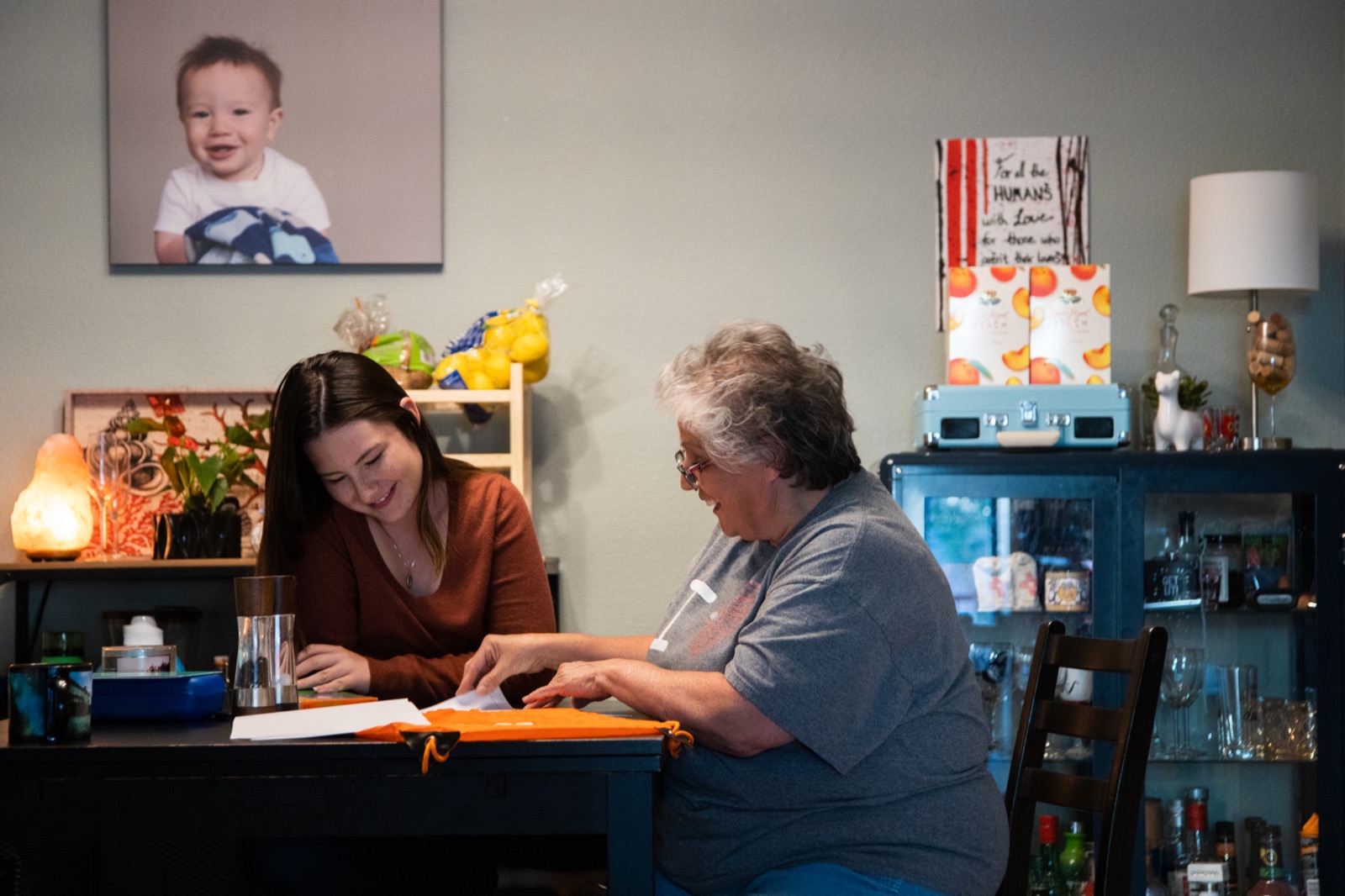 Case manager working with a client at her kitchen table